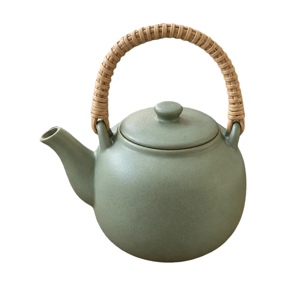 Sage-green teapot with a rattan handle, centred on a pure white square and filling most of it